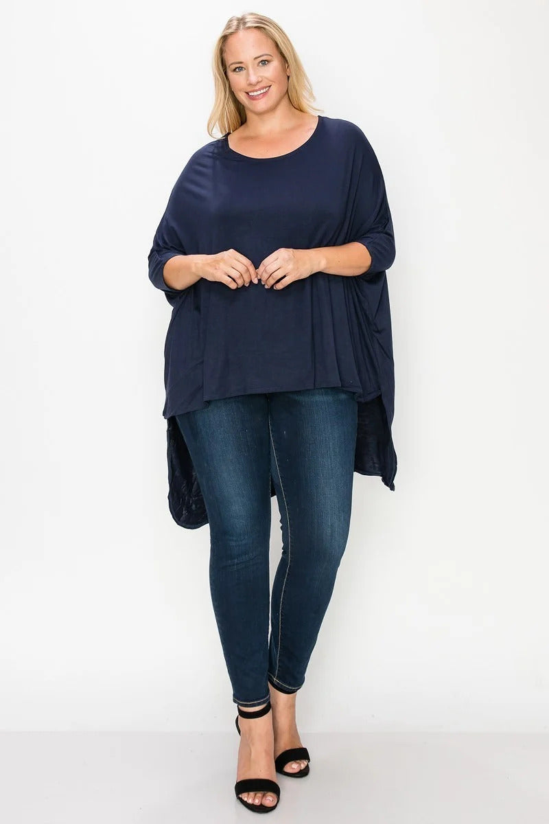 Solid top featuring a round neck, three quarter sleeves, and a high-low hem